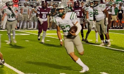 Hokes Bluff’s Brenton Hale runs for the first of his three touchdowns at Anniston on Friday. The Eagles won, 37-18. (Photo by Joe Medley)