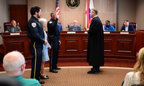 Etowah County Probate Judge Scott Hassell swears in Gadsden State’s Sgt. David Bankson as part of the Mobile Crisis Assistance Team.