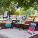 Artwork, flowers, photos, and mementos surround the plaque and bench that were dedicated to the memory of student Leah Grace Tarvin, who passed away in November 2022. (JSU Photo)