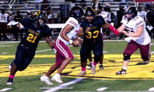 Cherokee County’s Tae Diamond (21) and Caleb Harbour (33) close in to tackle Anniston’s Damon Pope on Friday night. (Photo by Shannon Fagan/WEIS Sports Director)