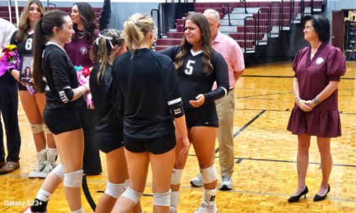 Teammates present Donoho’s Sam Wakefield flowers during the Falcons’ senior-night celebration before their area match against Weaver on Tuesday. (Photo by Joe Medley)