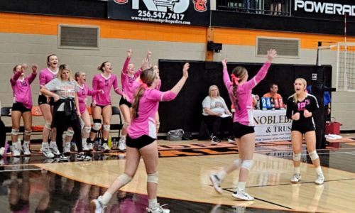 Alexandria players celebrate after finishing off their victory over Donoho in Saturday’s Calhoun County semifinals in Larry R. Ginn Gymnasium. (Photo by Joe Medley)