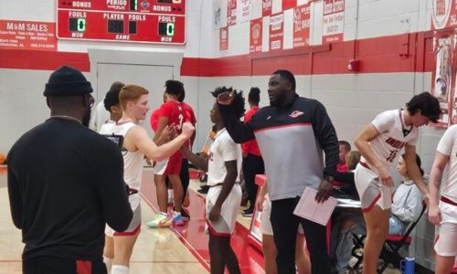 First-year Ohatchee coach Quntarius Hutchison shares a moment with Colby Hester before tipoff Thursday at Ohatchee. The Indians won Hutchison’s first game as a varsity head coach, beating Munford 57-45. (Photo by Joe Medley)