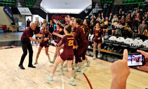 Spring Garden coach Ricky Austin hands the school’s latest state–title trophy in volleyball to his team following their victory over University Charter in Thursday’s Class 1A final in Birmingham’s Bill Harris Arena. (Photo by Joe Medley)