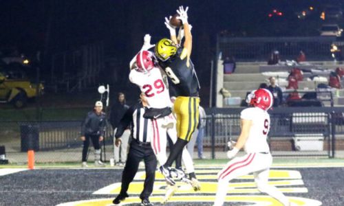 Oxford’s Nick Richardson goes up between defenders to pull down a touchdown reception just before halftime of the Yellow Jackets’ 34-14 victory over Hartselle in Friday’s second-round playoff game at Oxford. (Photo by Greg Warren/For East Alabama Sports Today)