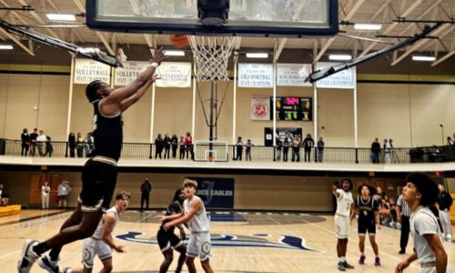 Oxford’s Jayden Lewis goes up for an alleyoop pass from from Jaylen Alexander during the Yellow Jackets’ 80-48 victory at Jacksonville on Monday. (Photo by Joe Medley)