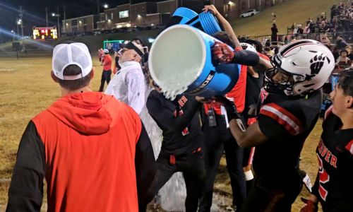 Weaver players douse second-year head coach Ken Cofer with a cooler after the Bearcats beat J.B. Pennington on Friday to lock up a playoff berth. (Photo by Joe Medley)