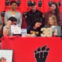 Weaver volleyball standout Jadey Hatten-Rivera, surrounded by family and Southern Union coaches, signs to play for the Bison. The Southern Union coaches present are (standing, from left) assistant Regina Smith and head coach Ametrice Jackson. (Photo by Joe Medley)