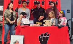 Weaver volleyball standout Jadey Hatten-Rivera, surrounded by family and Southern Union coaches, signs to play for the Bison. The Southern Union coaches present are (standing, from left) assistant Regina Smith and head coach Ametrice Jackson. (Photo by Joe Medley)