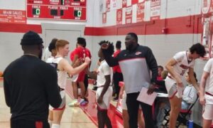 First-year Ohatchee coach Quntarius Hutchison shares a moment with Colby Hester before tipoff Thursday at Ohatchee. The Indians won Hutchison’s first game as a varsity head coach, beating Munford 57-45. (Photo by Joe Medley)