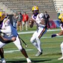 Jackson quarterback Landon Duckworth sets to throw as lineman Steven Taite (50) and back Gavin Jackson (26) block up front (Photo by David Holtsford/AHSAA)