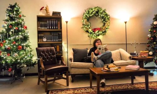 Ryan Kelly, Gadsden State Fine Arts student, sits back to enjoy the Christmas atmosphere after decorating for the performance.