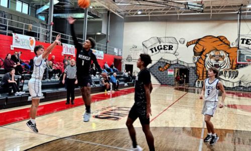 White Plains’ Crew Martin shoots a 3-pointer as Weaver’s Kaden Gooden defends during Friday’s action in the Heflin Holiday Hoops Classic. (Photo by Joe Medley/East Alabama Sports Today)