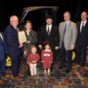 Whit and Amanda Lovelady of Talladega County received a prize package worth more than $70,000 as Alabama’s 2024 Outstanding Young Farm Family (OYFF) contest winner. The Loveladys were honored during the Alabama Farmers Federation’s 103rd annual meeting in Montgomery Dec. 9. From left are Federation Young Farmers Division Director Hunter McBrayer; Federation and Alfa President Jimmy Parnell; the Loveladys; Alabama Ag Credit’s Doug Thiessen; and Alabama Farm Credit’s Mel Koller.