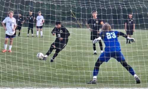 Oxford’s Joseph Bartolon blasts a penalty kick against White Plains during Thursday’s Calhoun County championship match at Choccolocco Park. (Photo by Joe Medley/East Alabama Sports Today)