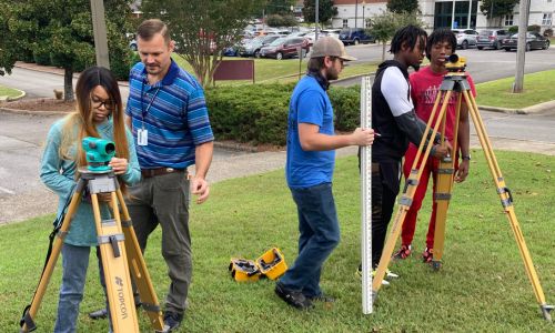 Gadsden State instructor, Marshall Bailey (second from left), encourages hands-on learning. Above, he is pictured with students in the Civil Engineering Technology program.