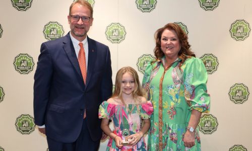 Millie Henderson of Calhoun County was honored for earning sixth place in the Alabama Farm-City Fourth-Sixth Grade Poster Contest April 17 during an annual awards luncheon in Auburn. Henderson is a student at Ohatchee Elementary School. They received $25 from Alabama Ag in the Classroom (AITC) for their poster, which showcased the theme of “Our Community Counts on Farmers.” From left are Alabama Farm-City Committee Chair Jeff Helms, Henderson and Alabama AITC Steering Committee Chair Kim Earwood.