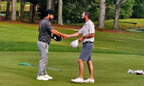Cody Robinson (left) shakes hands with Brennan Clay after their second attempt at a playoff hole to finish the Pine Hill Invitational on Sunday. (Photo by Joe Medley/East Alabama Sports Today)