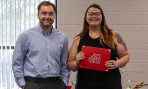 Eleaxus Pettus is awarded the Presidential Scholarship from Jacksonville State University by Tucker Allen, Admissions Counselor at JSU.