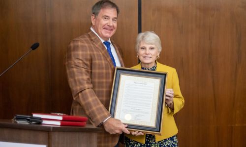 Gadsden Mayor Craig Ford (left) presents the proclamation for Dr. Kathy Murphy Day to Dr. Kathy Murphy (right) at Gadsden City Hall.