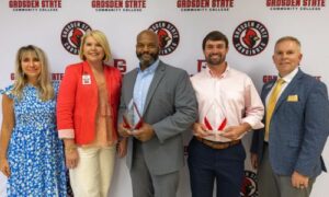 Outgoing President Tommie Goggans, III (middle) and outgoing Treasurer, Bryan Dorsett (second from right) were recognized for their leadership at the recent board meeting with Executive Vice President Dr. Tera Simmons (left), Cardinal Foundation Director Hillary Folsom (second from left), and Interim President Alan Smith (right).