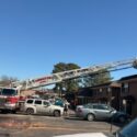 Photo of Fire Ladder truck extended over building during fire