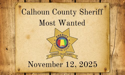 Most wanted cover photo - Wester paper tacked to wood planks. Words Calhoun County Sheriff Most Wanted with photo of sheriff badge