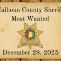 Most wanted poster on wood background with Sheriff Star