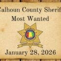 photo of old west paper with most wanted on it with the sheriff's office on a wood background