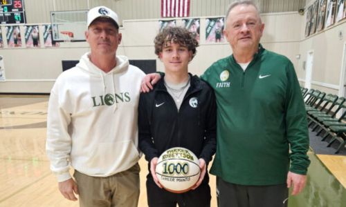 Faith Christian’s Parker Roberson poses with his father Barry (left) and Faith coach Doug Ward during Tuesday’s ceremony to celebrate his having scored 1,000 career points. (Submitted photo)