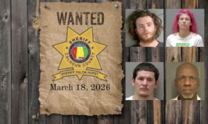 Most wanted poster with sheriff star nailed to a wood plank wall with 4 mugshots of wanted people