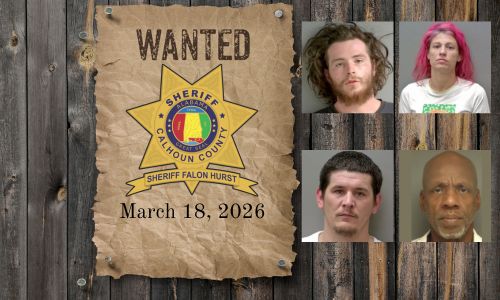 Most wanted poster with sheriff star nailed to a wood plank wall with 4 mugshots of wanted people