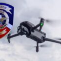 Photo of Anniston Police Patch with drone in background flying