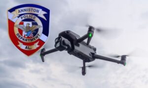 Photo of Anniston Police Patch with drone in background flying