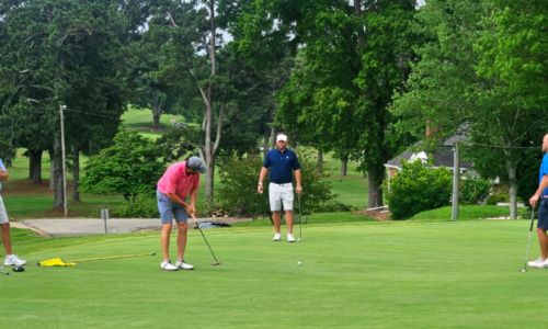 Andrew Brooks putts on No. 16 as (from left) Ted Gregerson, Jeremy McGatha and Aaron Gregerson watch during Friday’s play in the Wilfred Galbraith Invitational at Anniston Country Club. (Photo by Joe Medley/East Alabama Sports Today)
