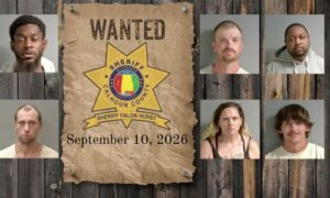 Wanted photo with 6 mugshots on old west wood planked wall with wanted poster and Sheriff's Office star