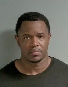 Jail photo of black male wearing a black t-shirt