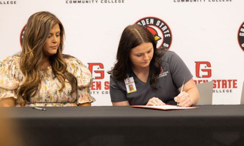 Nursing student Brittany Aul signs an apprenticeship agreement with Marshall Medical Centers during Gadsden State Community College’s Nursing Apprenticeship signing ceremony