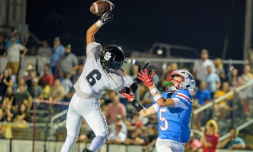 Wellborn’s Thane Do land tips a pass away from Pleasant Valley’s Cooper Dougal on Friday at Pleasant Valley. (Photo by Brad Campbell/sport-shutter.com)