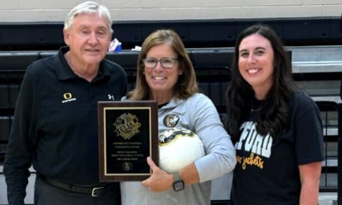 Oxford volleyball coach Wendy McKibbin celebrates reaching 900 career victories with Oxford athletics director Larry Davison and Oxford assistant coach Chelsea Robinson on Tuesday. (Submitted photo)