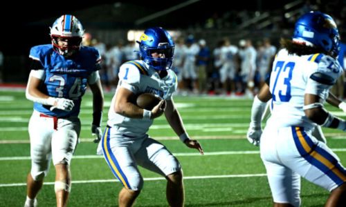 Piedmont quarterback Cole Austin (1) carries the ball as Frederic Taylor II (73) blocks and Pleasant Valley’s Hayden Hardy pursues Friday at Pleasant Valley. (Photo by Ken Grissom/For East Alabama Sports Today)
